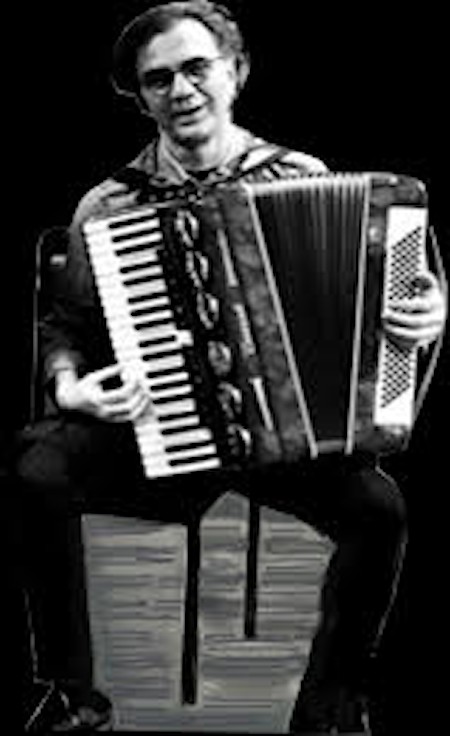 A Greek man joyfully playing an accordion